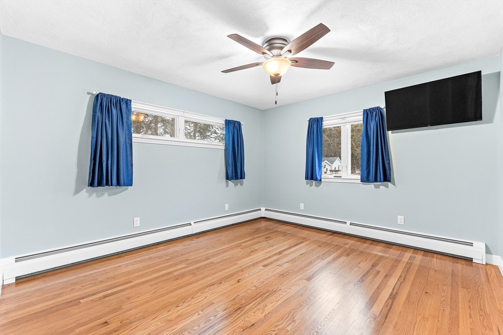 10 Viking Road Winchester, MA 01890 - Photo 27 of 42 a view of a livingroom with wooden floor and a ceiling fan