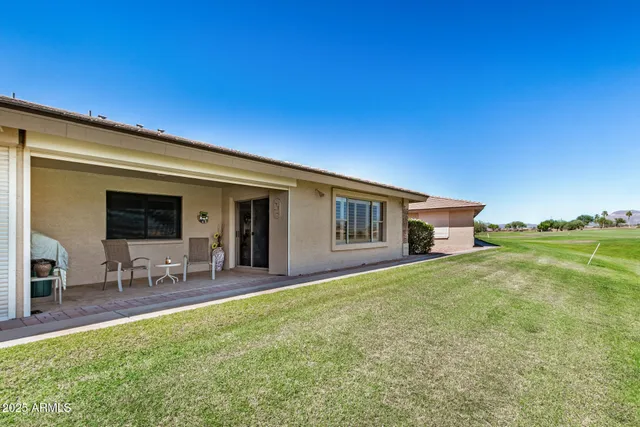 a house view with swimming pool and garden space