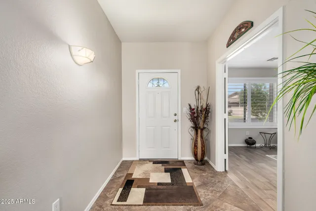 a view of a livingroom with wooden floor and a window