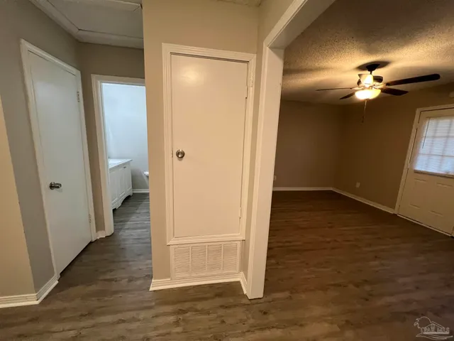 wooden floor in an empty room with a bathroom