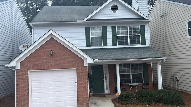 a view of brick house with large windows