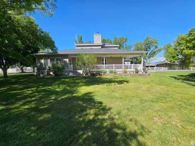 812 East Bates Cyn Road Tooele, UT 84074 - Photo 134 of 144 Expansive green lawn bordering a residence with a covered porch
