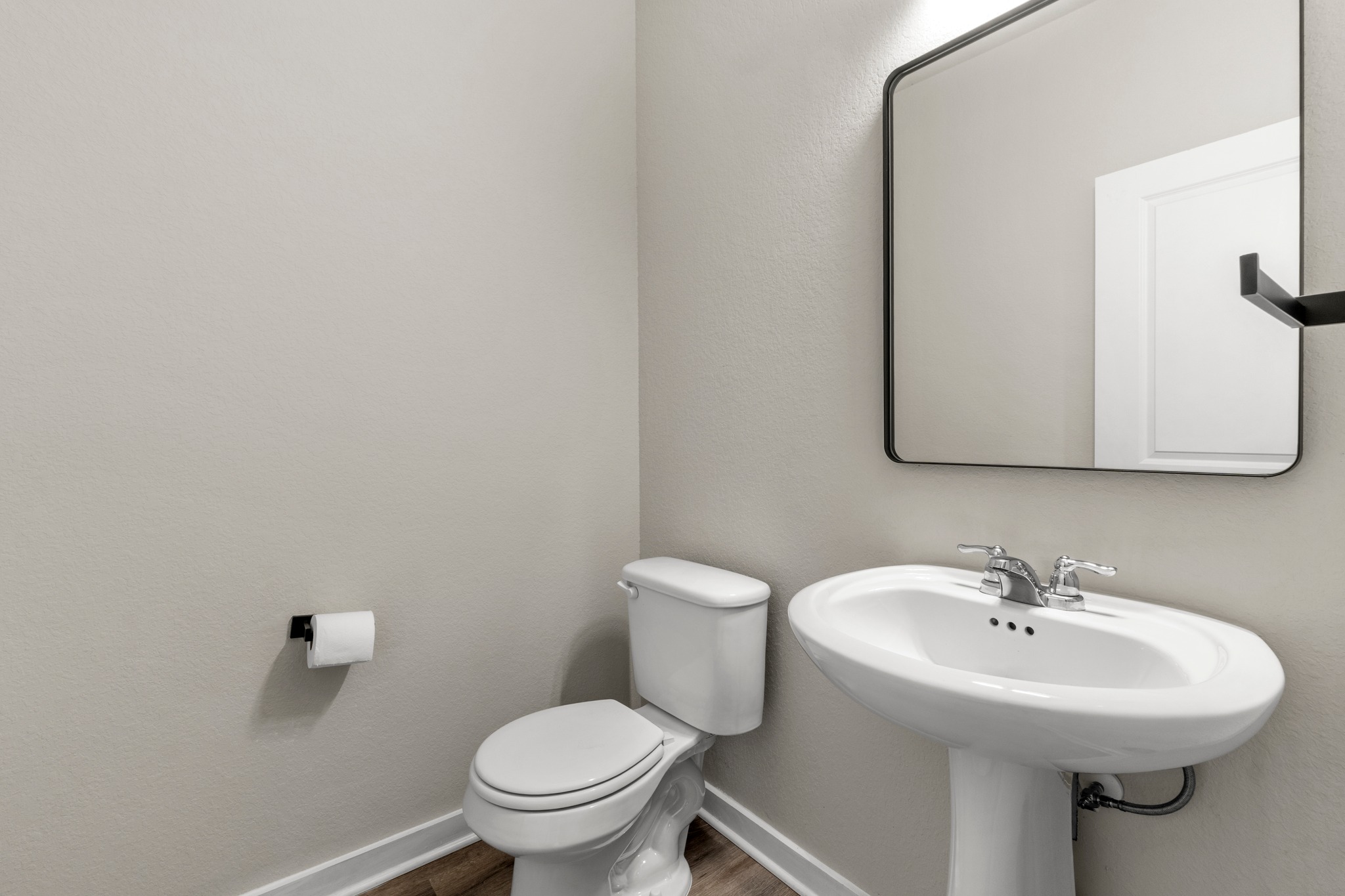 2251 Rocoso Trail Leander, TX 78641 - Photo 28 of 34 Smooth walls and a pedestal sink define this clean guest powder room.