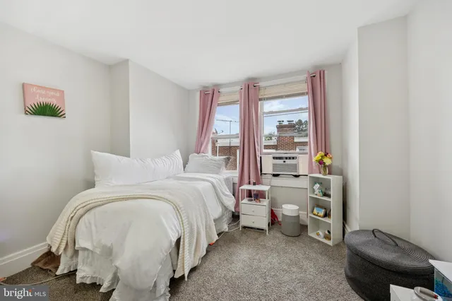 a bed room with a bed and a window