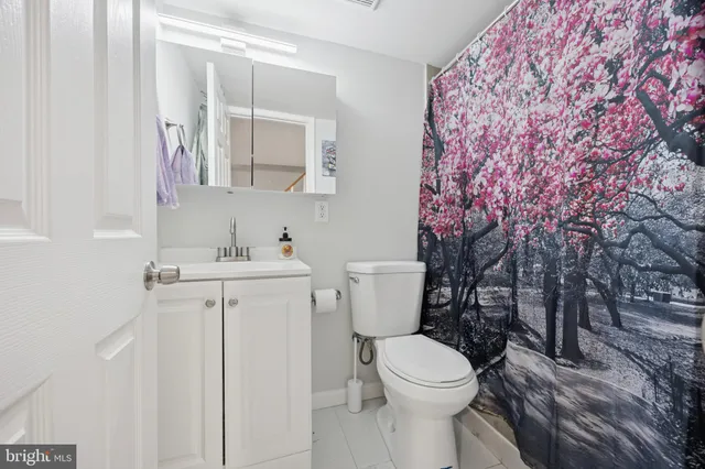a white toilet sitting next to a bathroom sink