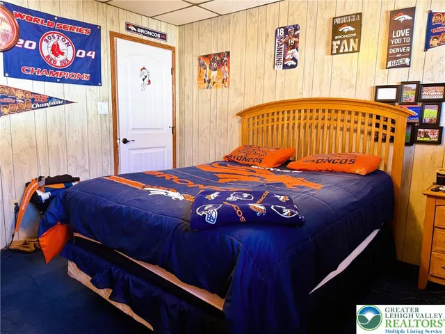 a bedroom with a bed and a baby crib