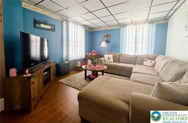 a living room with furniture and a flat screen tv