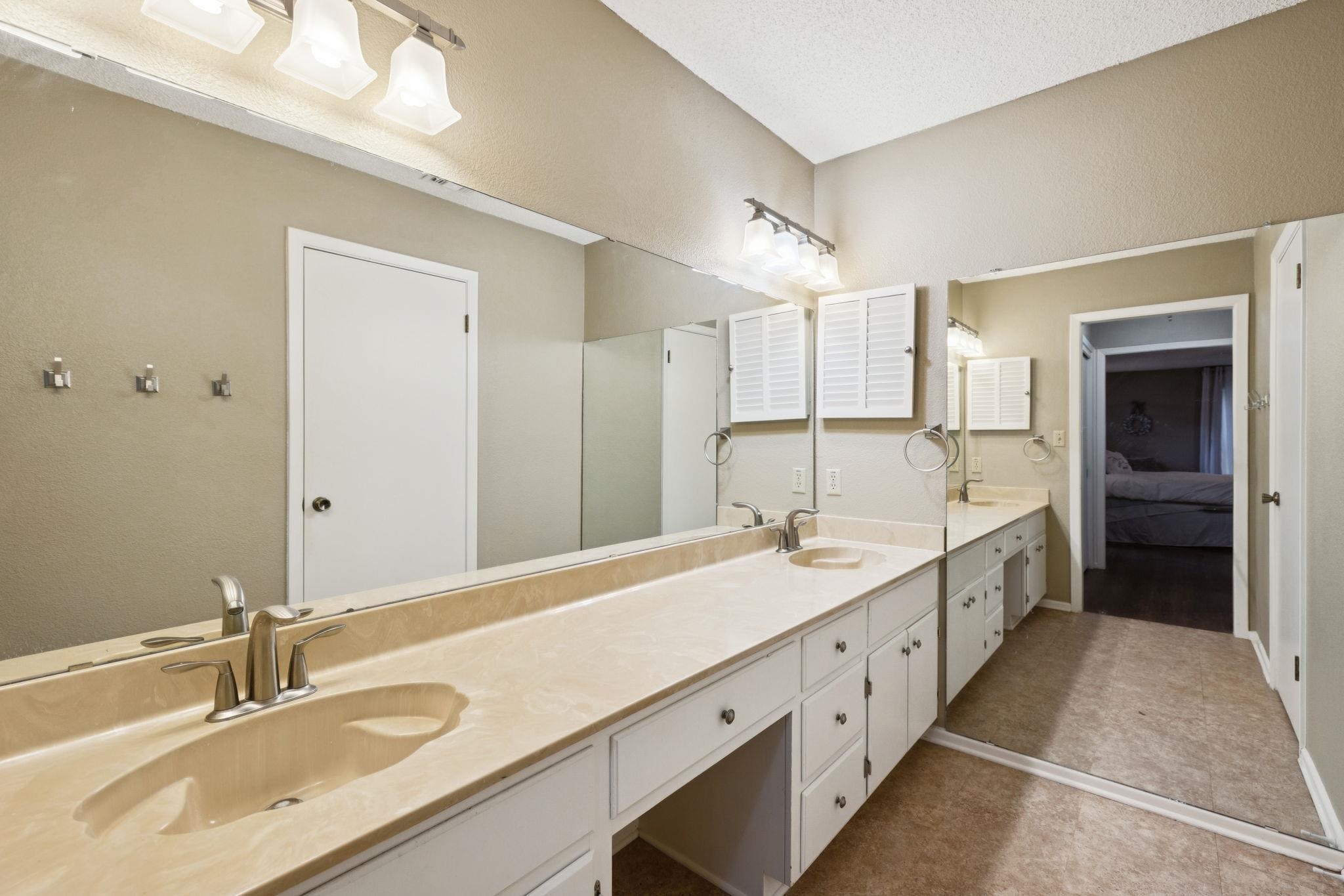 180 Wampum Way Seguin, TX 78155 - Photo 12 of 24 a spacious bathroom with a double vanity sink and a mirror