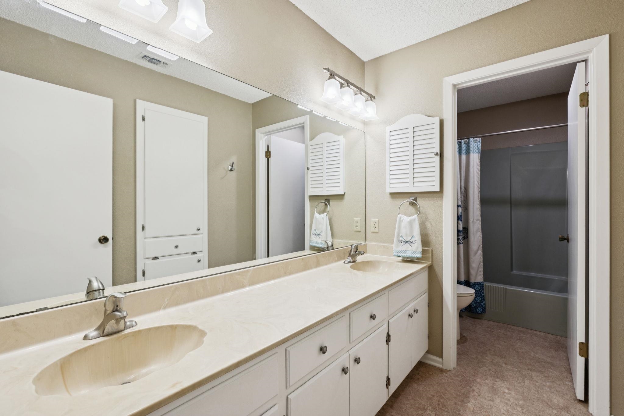 180 Wampum Way Seguin, TX 78155 - Photo 15 of 24 a bathroom with a double vanity sink mirror and double