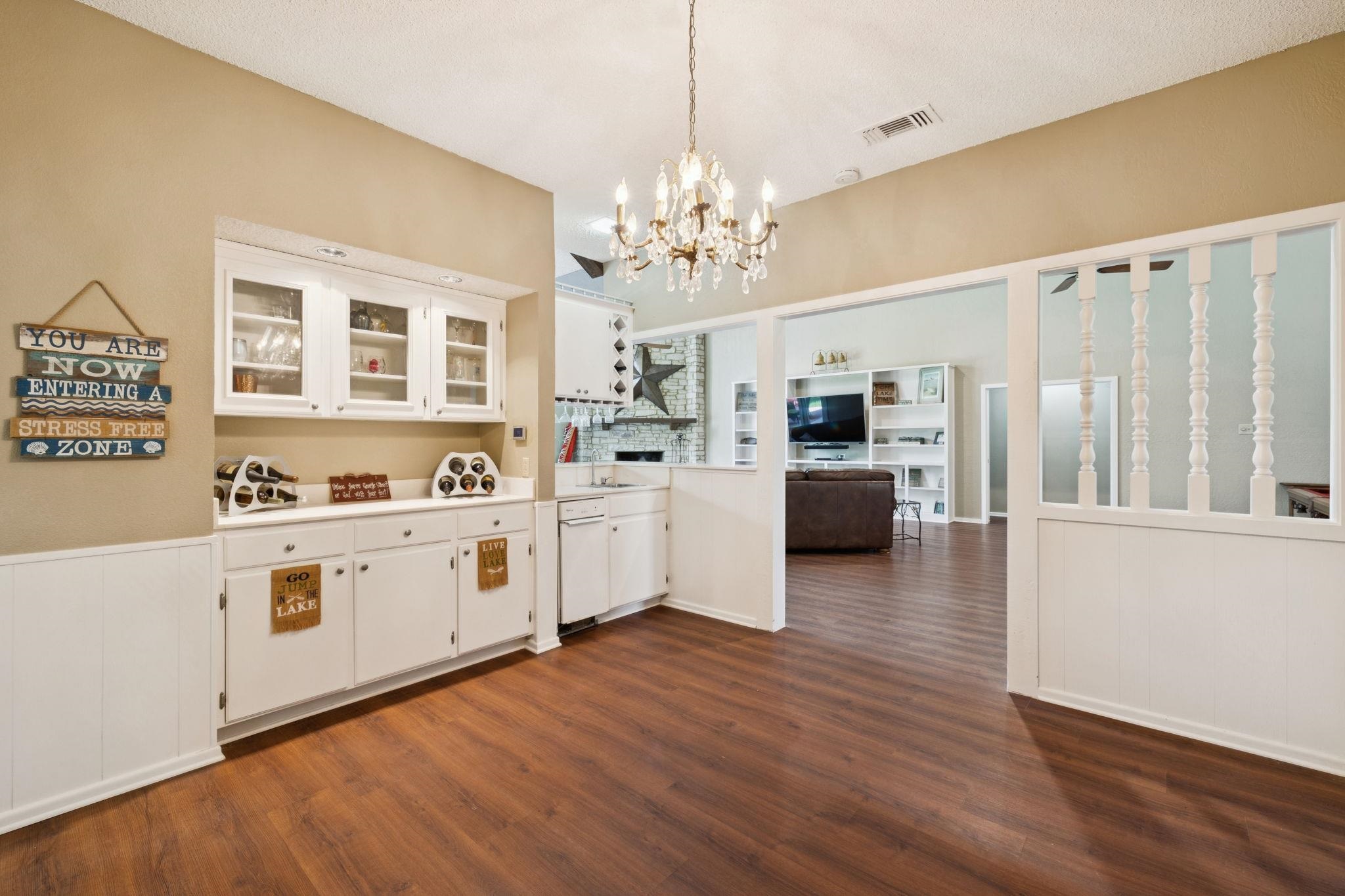 180 Wampum Way Seguin, TX 78155 - Photo 17 of 24 a large white kitchen with cabinets and wooden floor