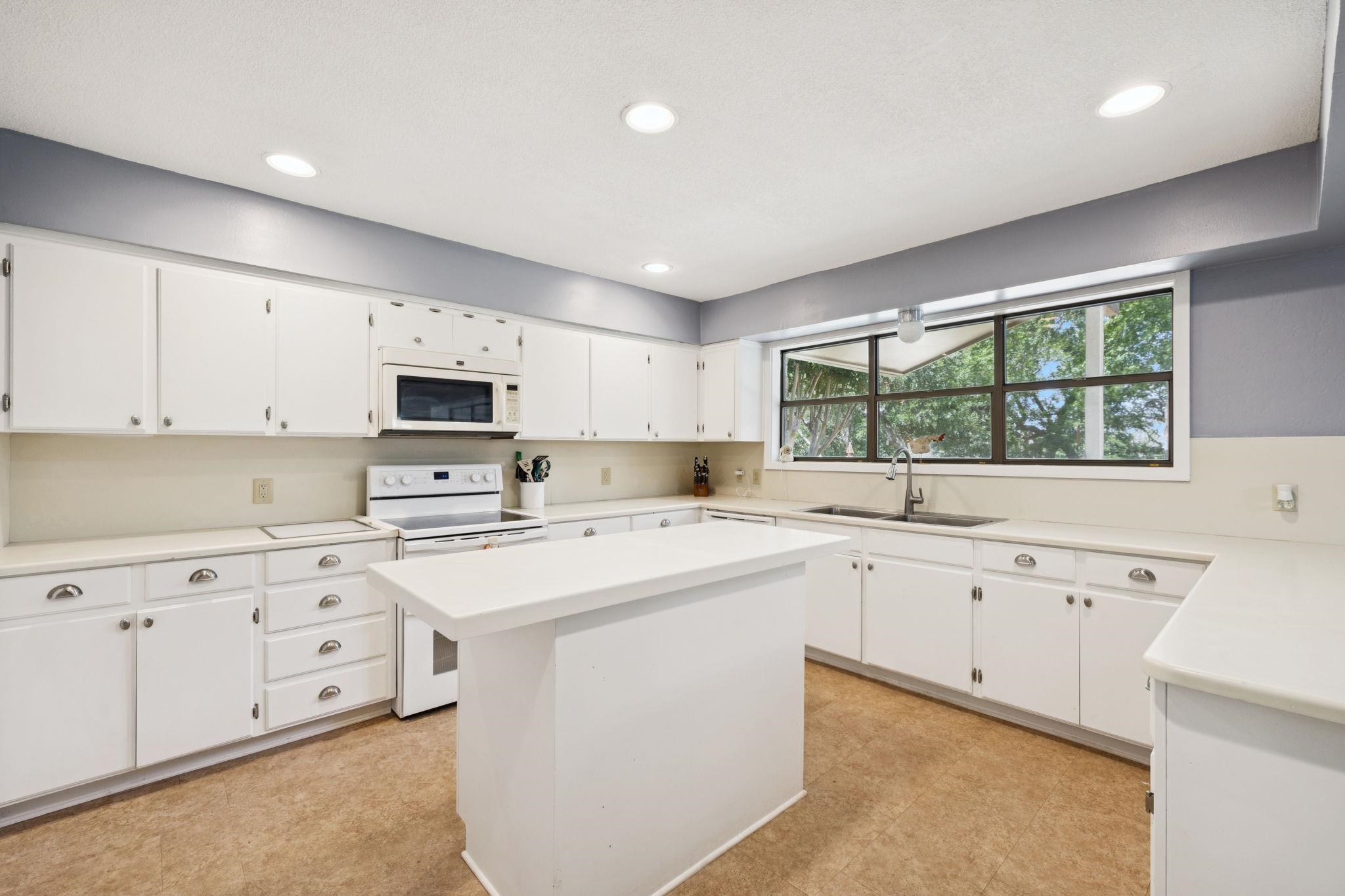 180 Wampum Way Seguin, TX 78155 - Photo 18 of 24 a kitchen with cabinets appliances a sink and a window