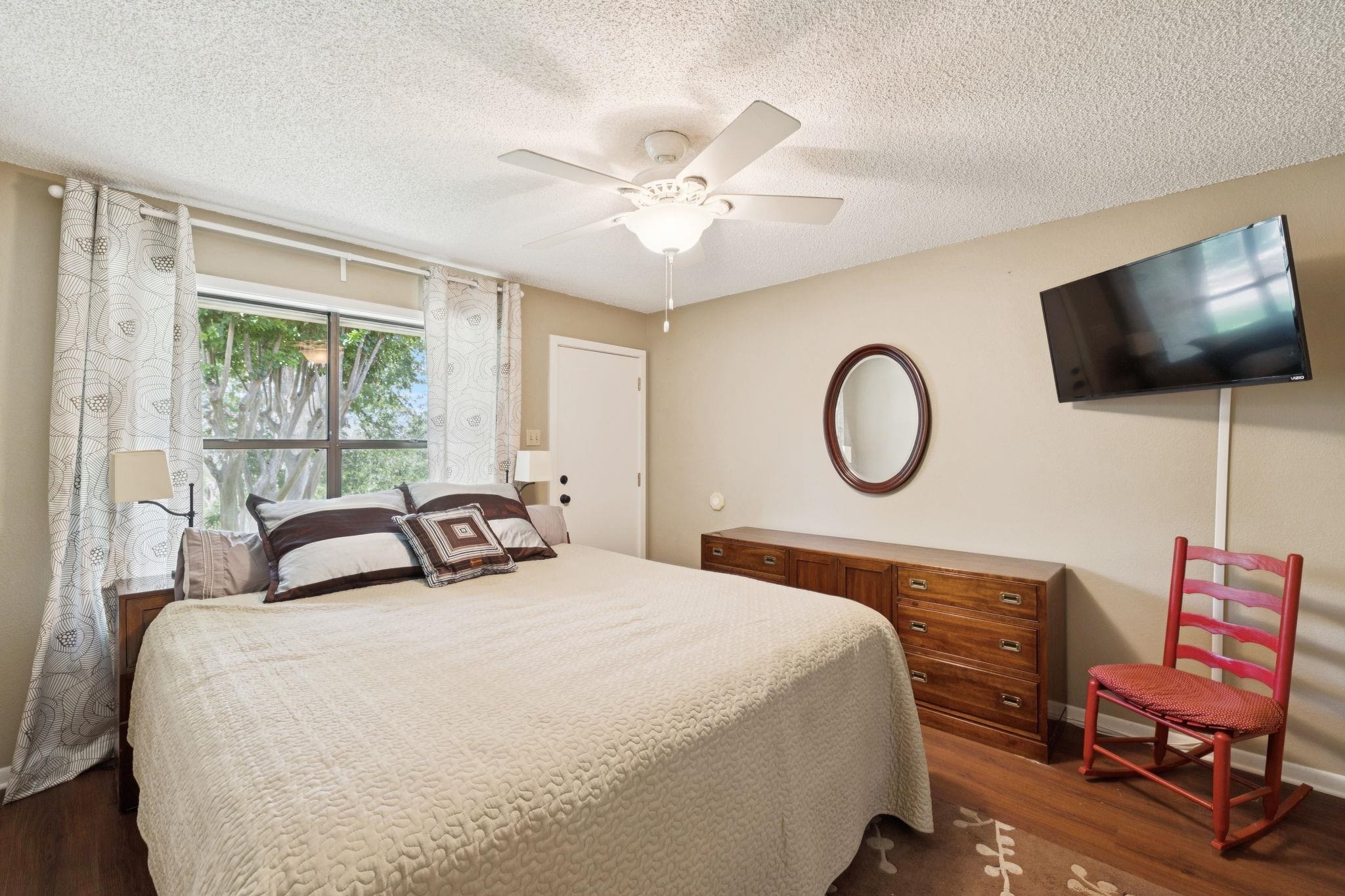 180 Wampum Way Seguin, TX 78155 - Photo 22 of 24 a bedroom with a bed and a flat screen tv