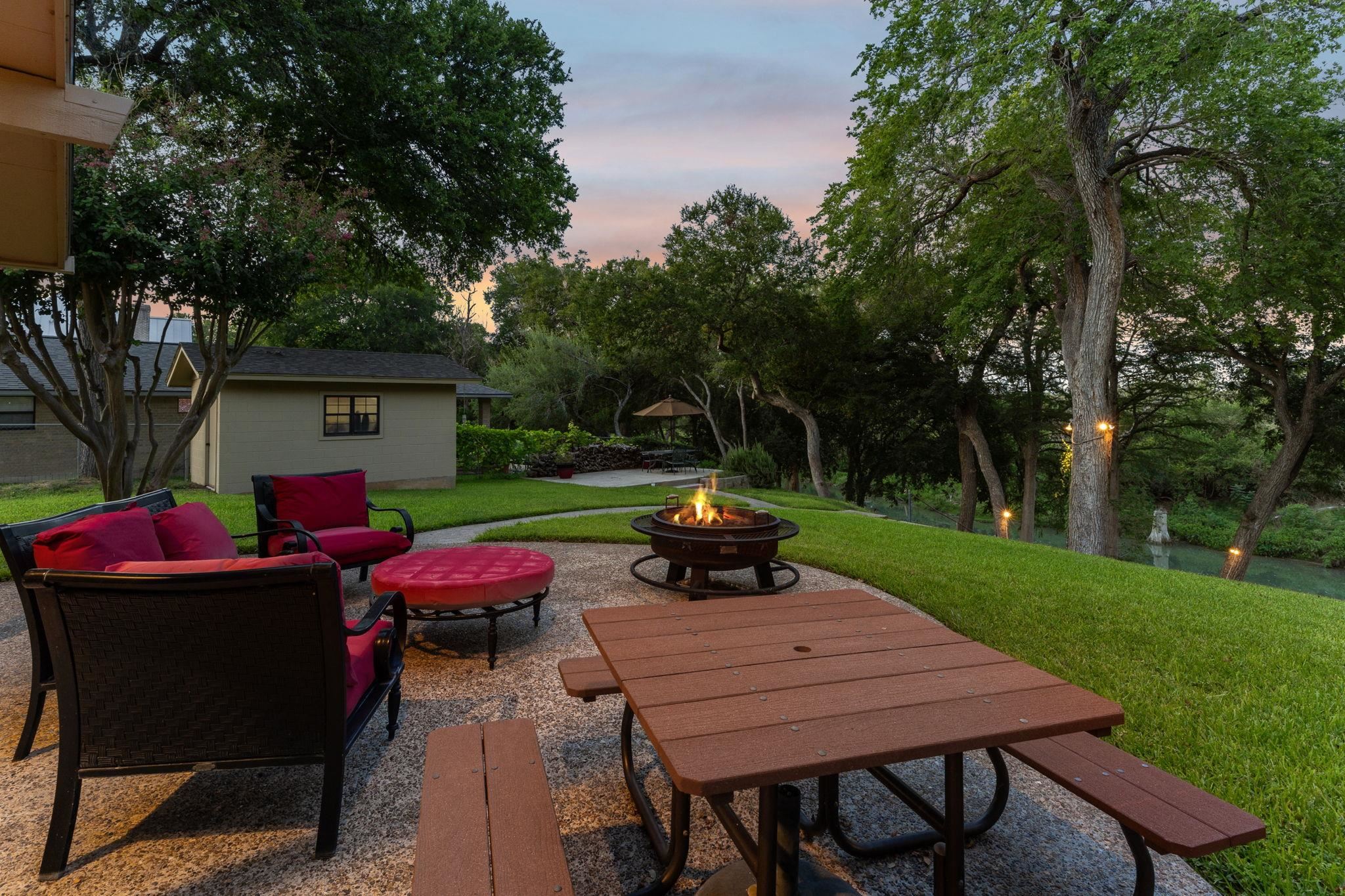 180 Wampum Way Seguin, TX 78155 - Photo 24 of 24 a view of a patio with table and chairs under an umbrella with large trees
