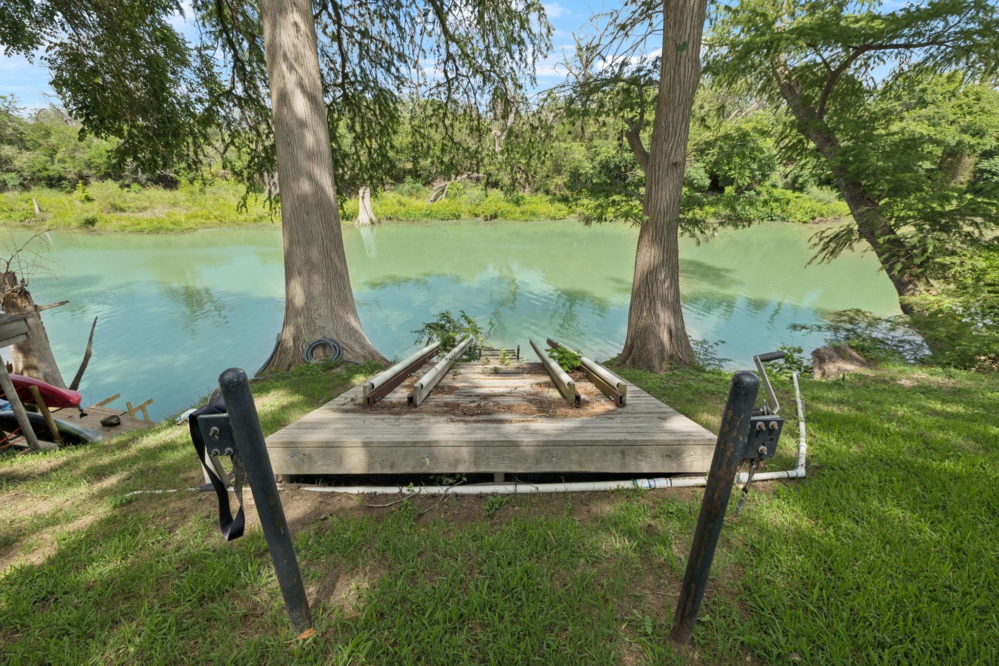 180 Wampum Way Seguin, TX 78155 - Photo 4 of 24 a view of a garden from a lake