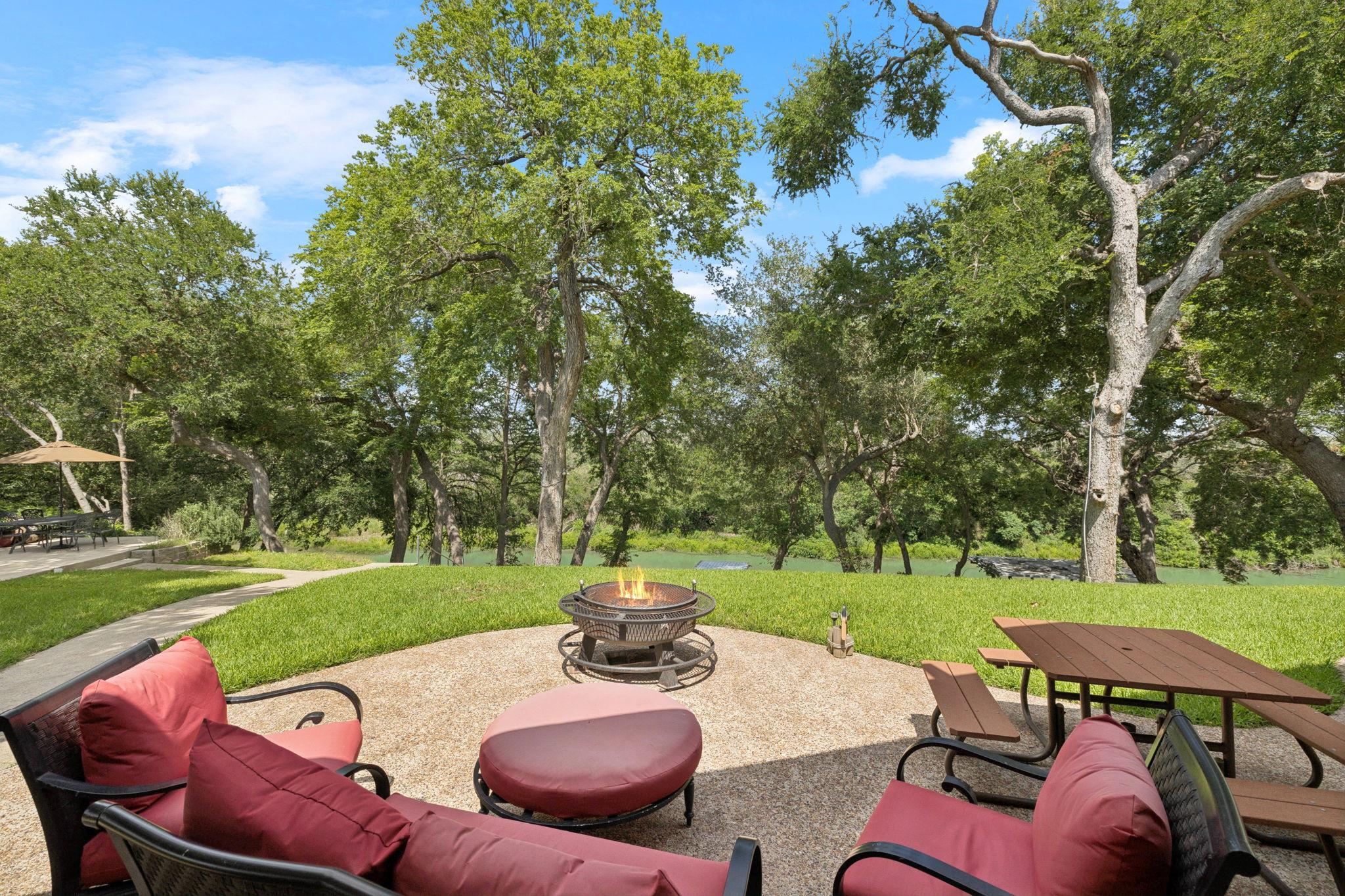 180 Wampum Way Seguin, TX 78155 - Photo 6 of 24 a view of a backyard with table and chairs potted plants and a palm tree