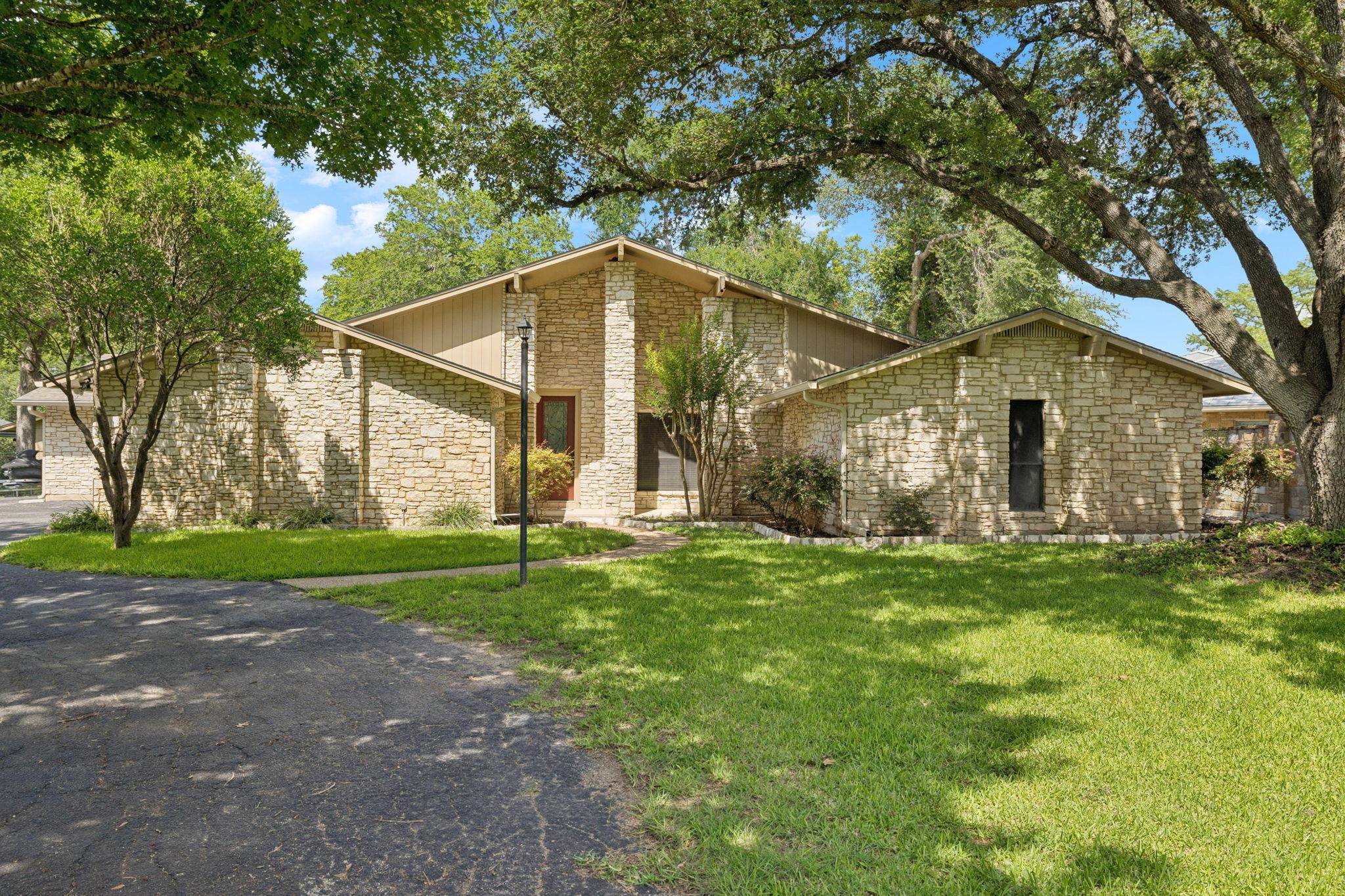 180 Wampum Way Seguin, TX 78155 - Photo 7 of 24 a view of a yard in front of a house with large trees