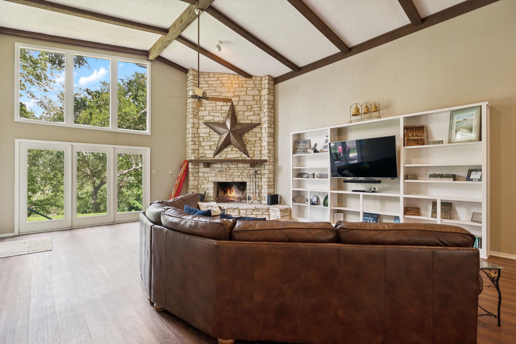 180 Wampum Way Seguin, TX 78155 - Photo 8 of 24 a living room with furniture a flat screen tv and a floor to ceiling window