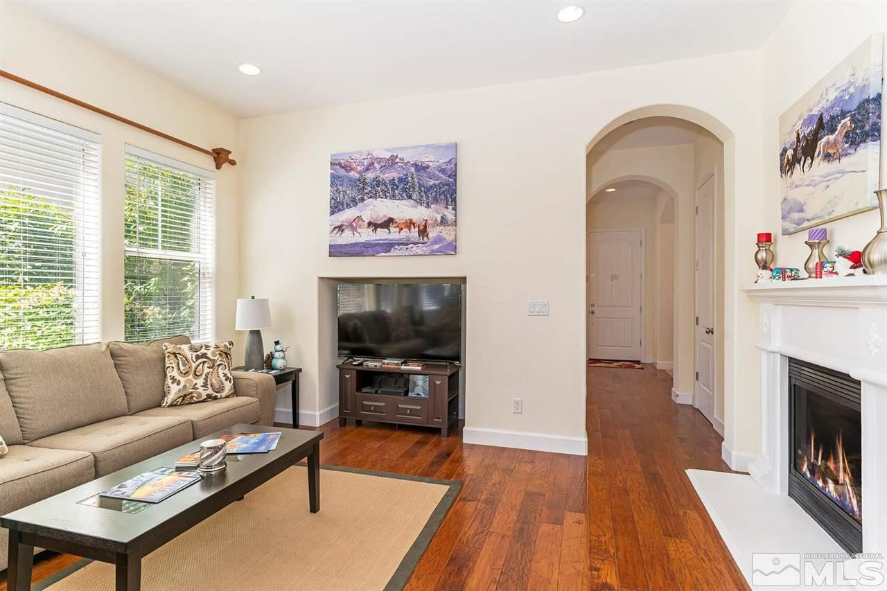 1644 Sawtooth Trail Reno, NV 89523 - Photo 5 of 15 a living room with furniture a flat screen tv and a fireplace