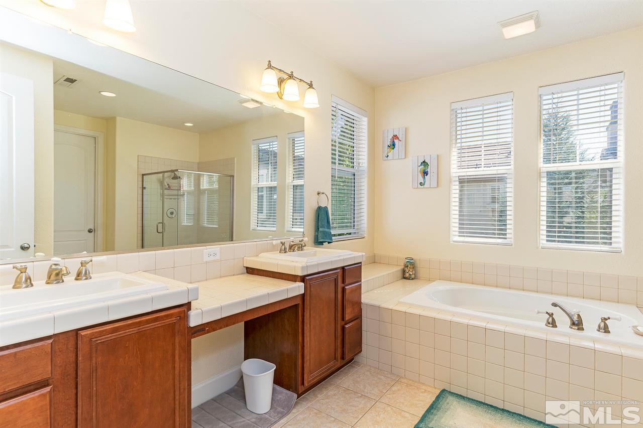 1644 Sawtooth Trail Reno, NV 89523 - Photo 10 of 15 a bathroom with a granite countertop tub sink and mirror