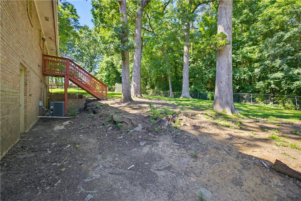 4188 Cedar Valley Lane Conley, GA 30288 - Photo 26 of 28 a backyard of a house with lots of green space