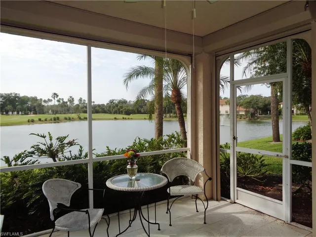 a dining room with furniture and a floor to ceiling window