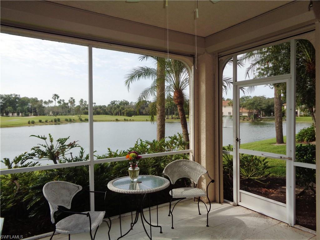a dining room with furniture and a floor to ceiling window
