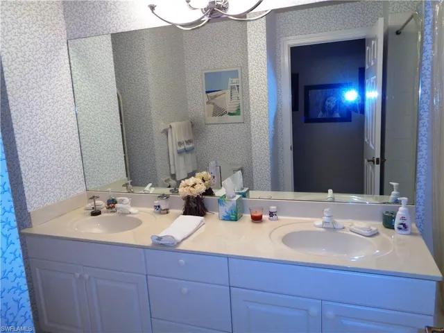 a bathroom with a sink toilet and mirror