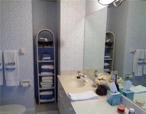 a bedroom with a bed and a lamp on table