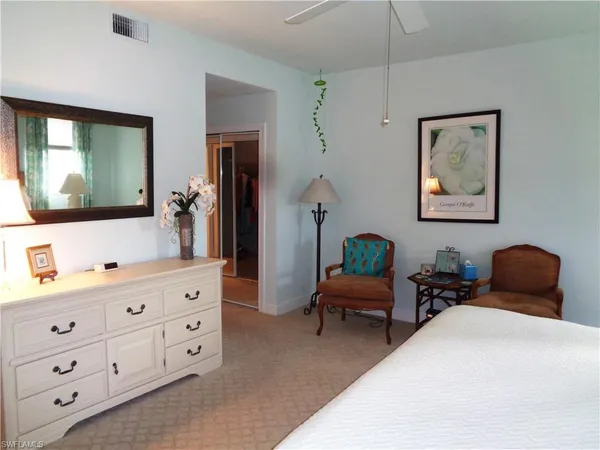 a living room with furniture and painting on the wall