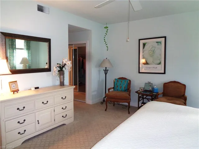 a living room with furniture and painting on the wall