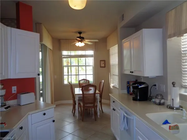 a kitchen with a sink cabinets and window