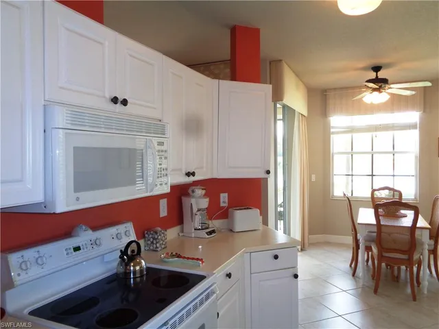 a view of a dining room with furniture and window