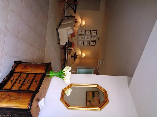 a living room with furniture a lamp and a flat screen tv