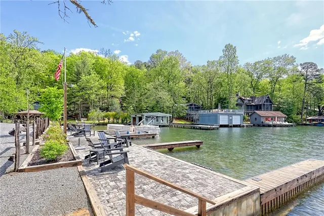 an aerial view of a house with porch yard basket ball court and trampoline