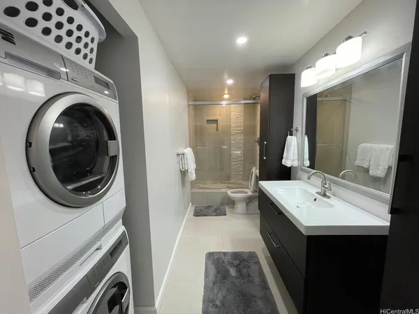 a bathroom with a sink a washer and dryer