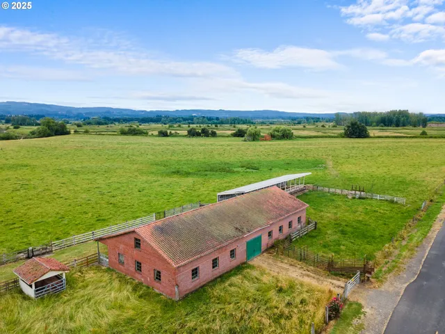 an aerial view of a house with big yard