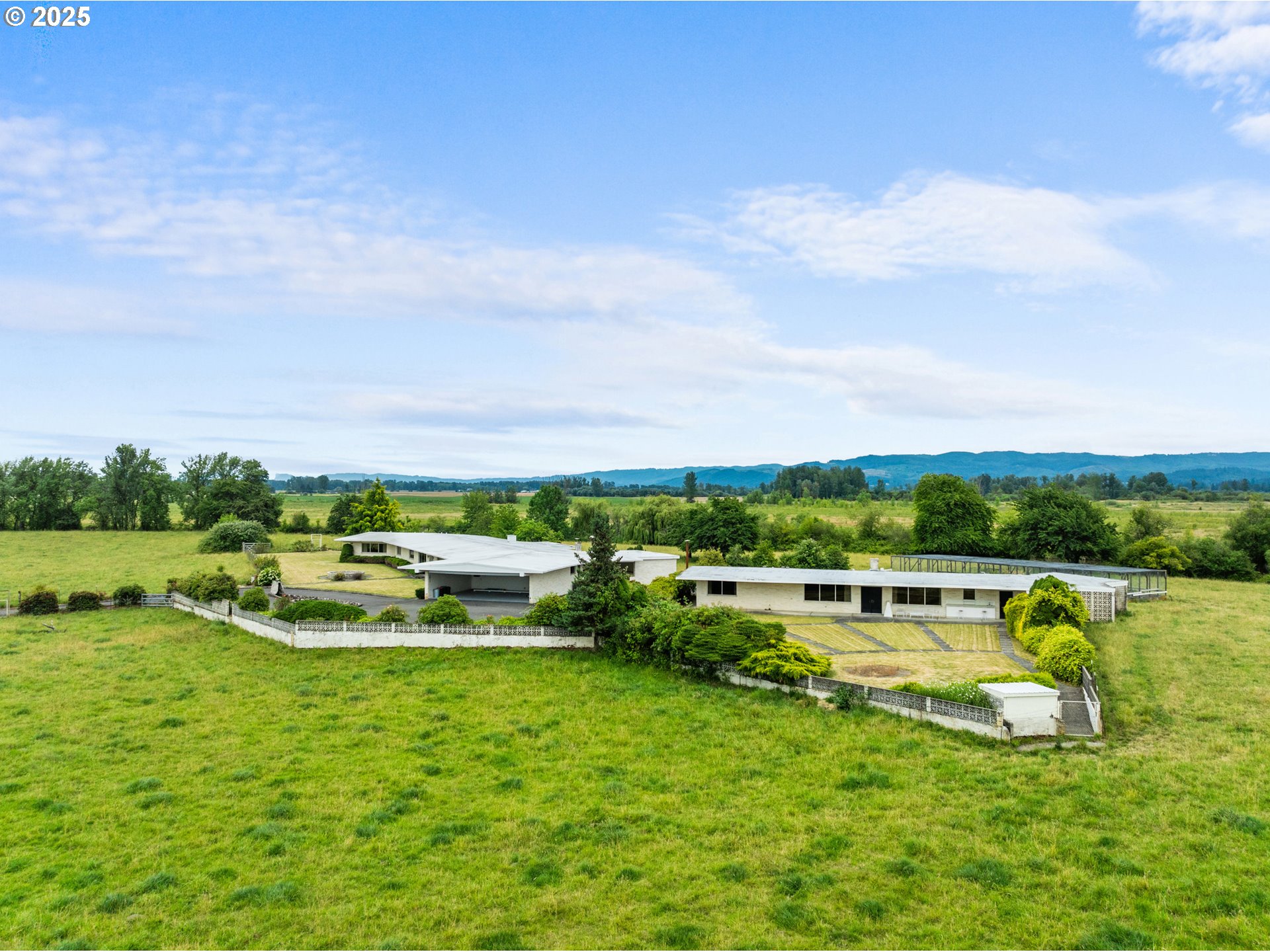 53767 East Honeyman Road Scappoose, OR 97056 - Photo 45 of 46 a view of a swimming pool with lawn chairs and large trees