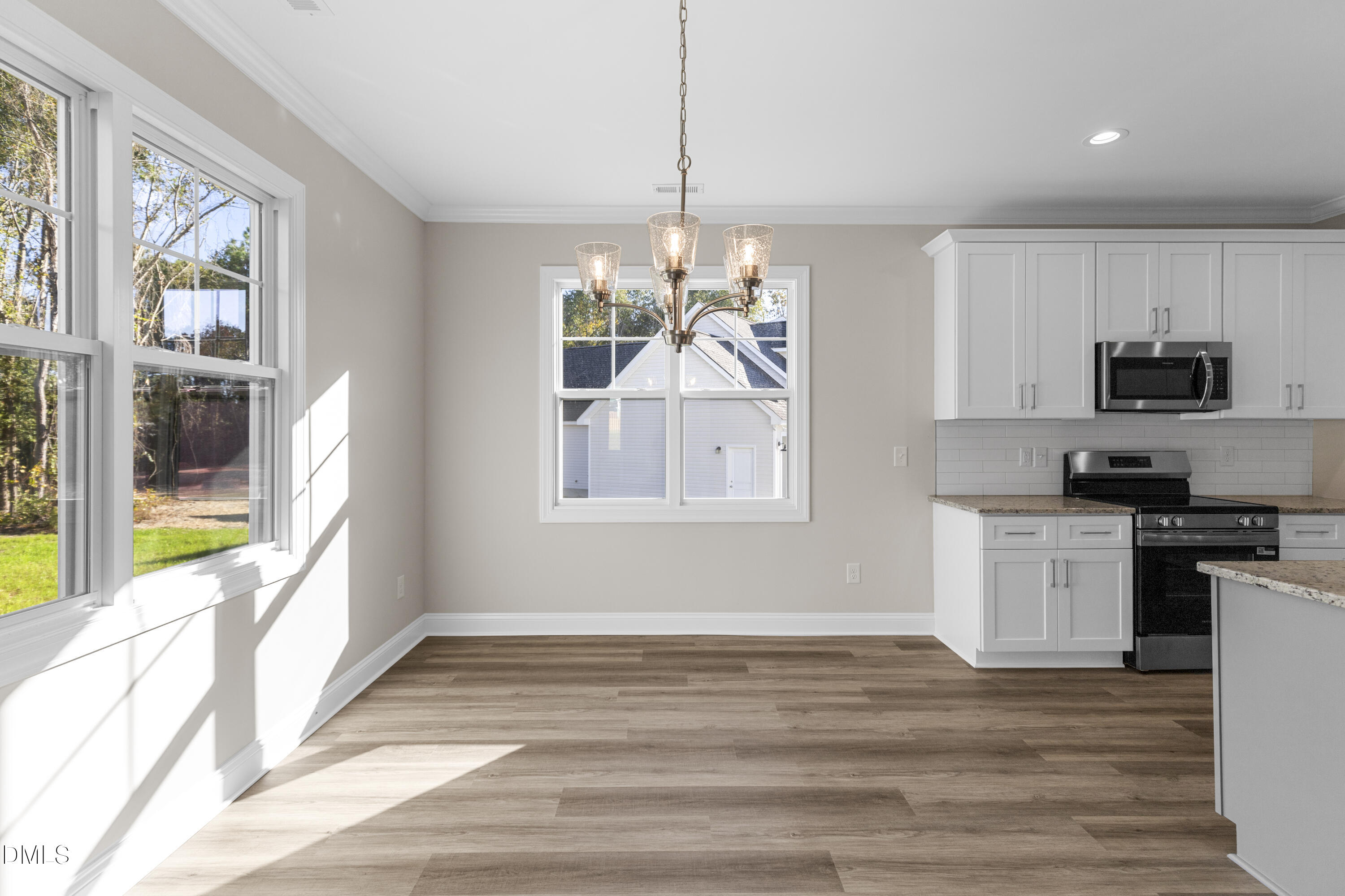 171 Surles Landing Way Benson, NC 27504 - Photo 12 of 29 a kitchen with stainless steel appliances granite countertop a stove a sink and a refrigerator with wooden floor