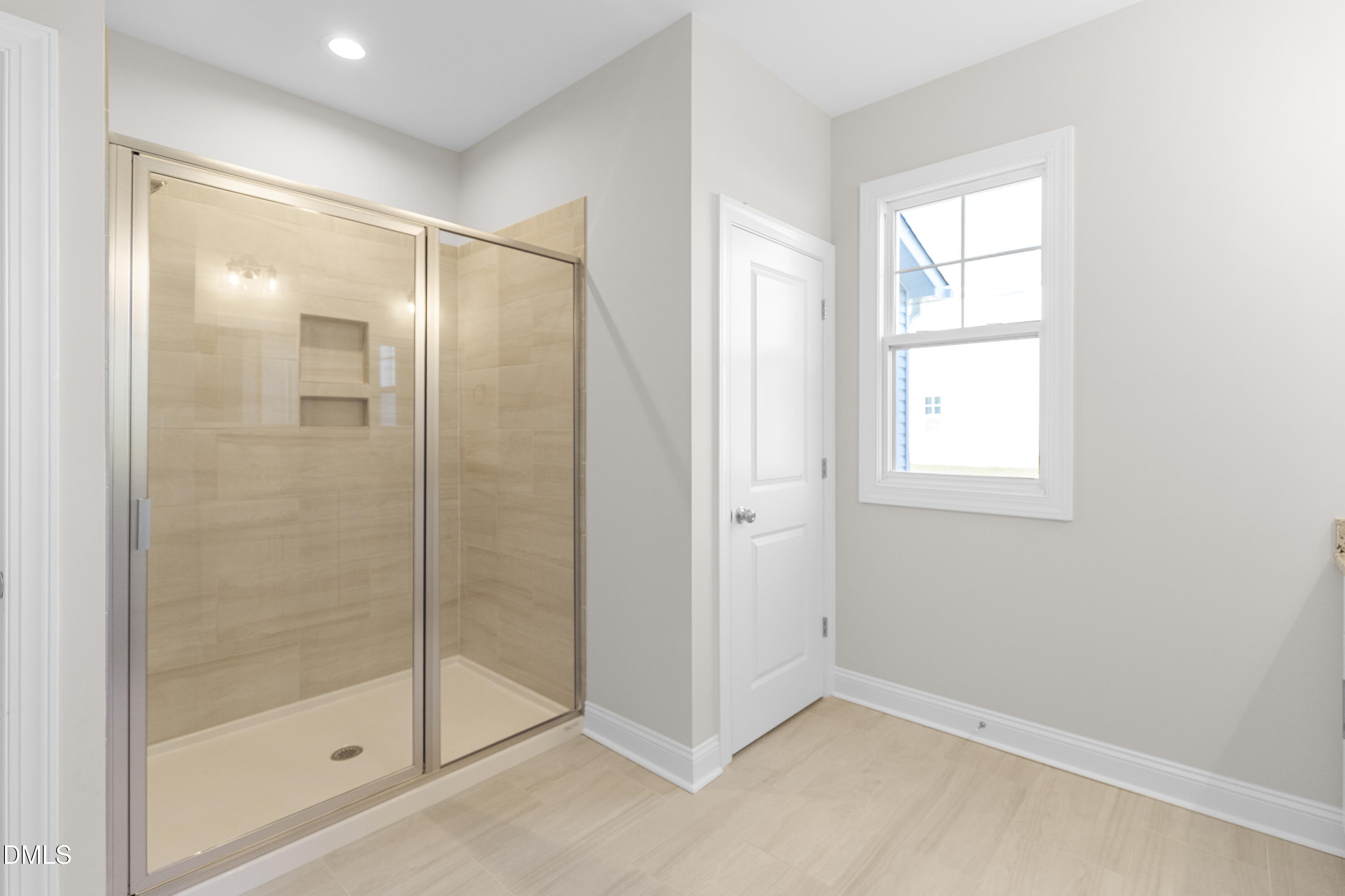 171 Surles Landing Way Benson, NC 27504 - Photo 16 of 29 a bathroom with a glass shower door