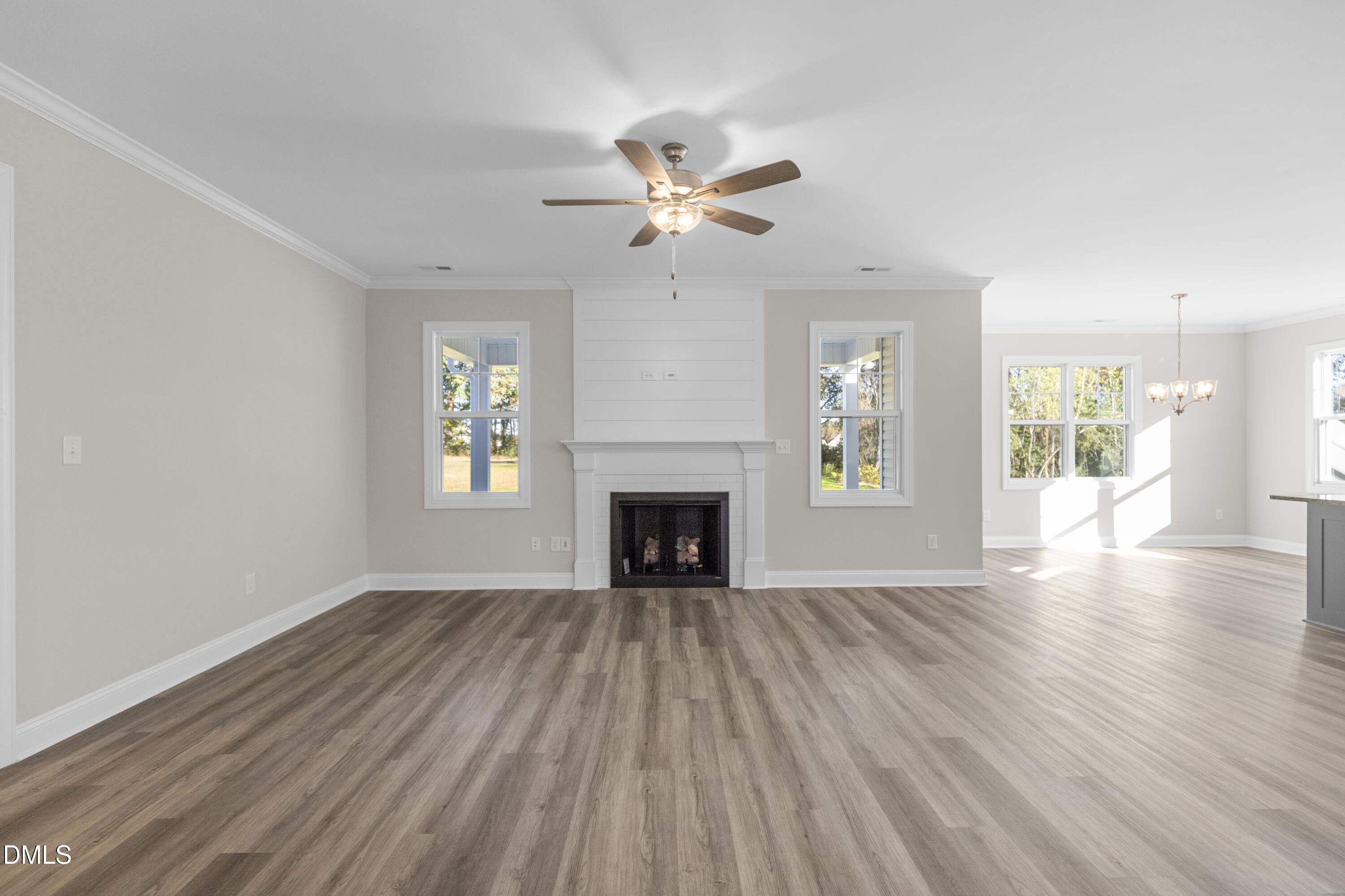 171 Surles Landing Way Benson, NC 27504 - Photo 6 of 29 wooden floor fireplace and windows in an empty room