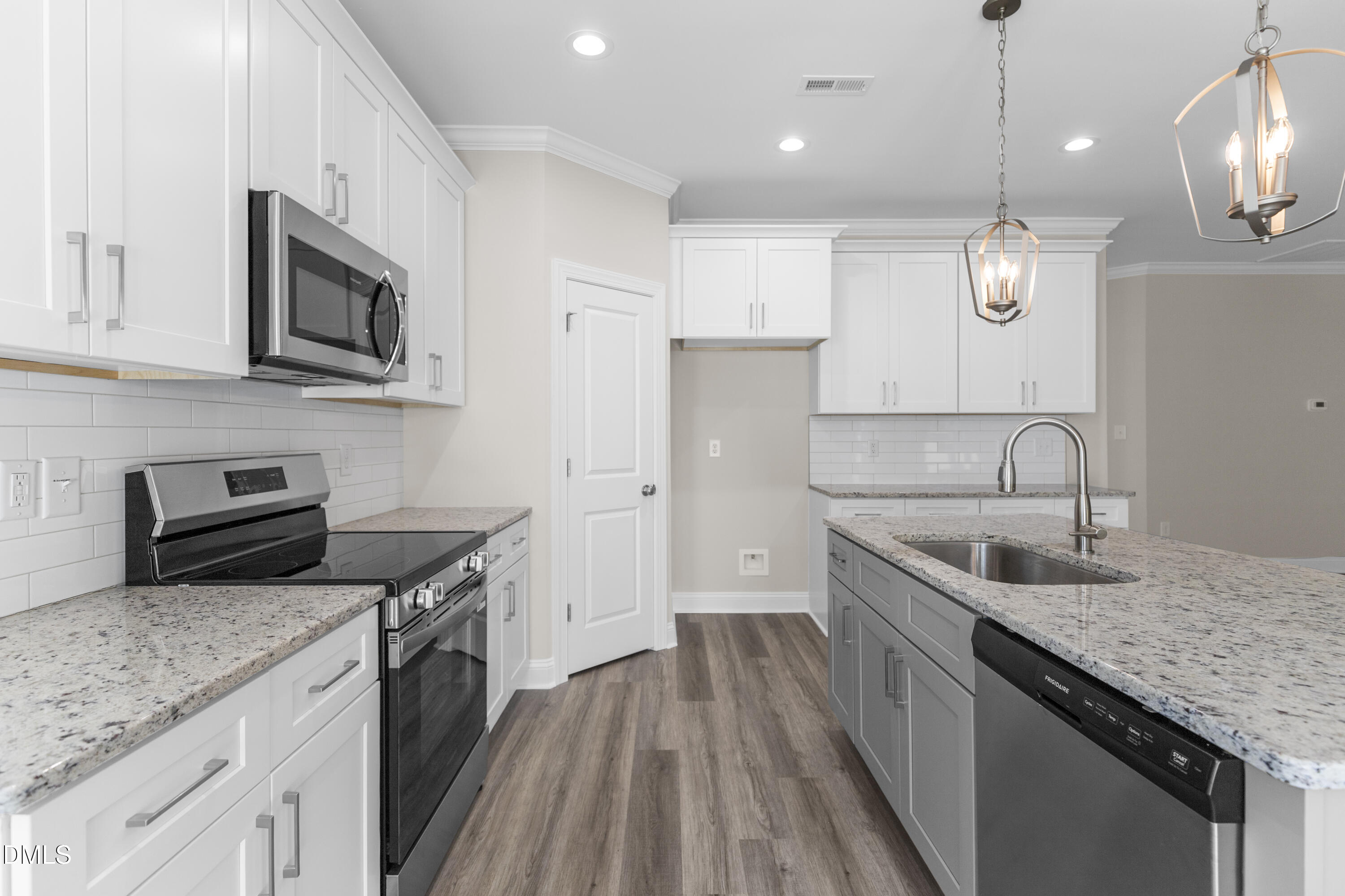 171 Surles Landing Way Benson, NC 27504 - Photo 8 of 29 a kitchen with stainless steel appliances granite countertop a sink stove and refrigerator