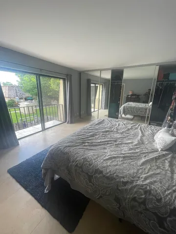 a bed sitting in a bedroom next to a window