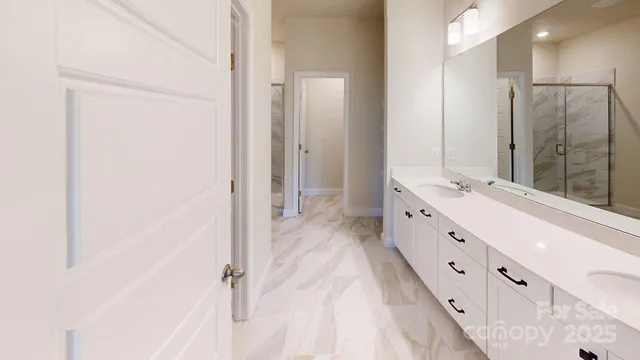 a spacious bathroom with a double vanity sink and a mirror