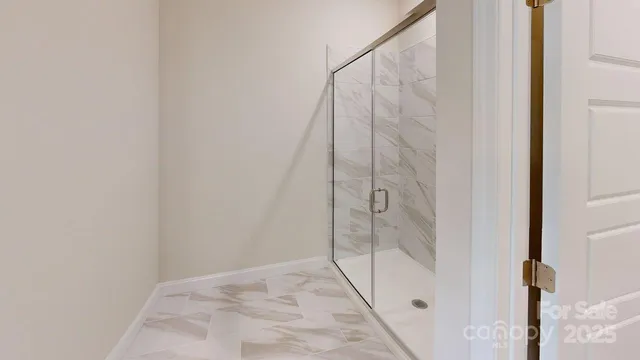 a bathroom with a glass door shower