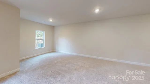 a view of an empty room and a window