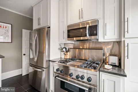 a kitchen with a stove and a microwave