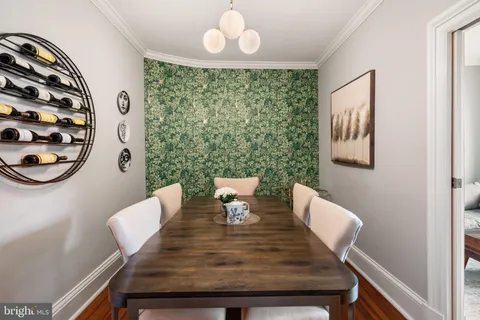 a view of a dining room with furniture and chandelier