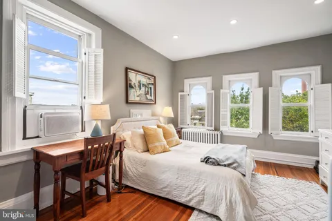 a bedroom with a bed and a table