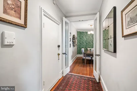 a view of a hallway and a livingroom with furniture