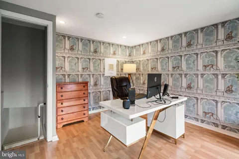 a living room with stainless steel appliances furniture a rug and a window